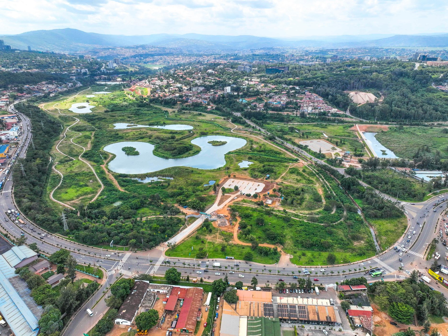 Aerial view across Kigali's green urban landscape and surrounding hills
