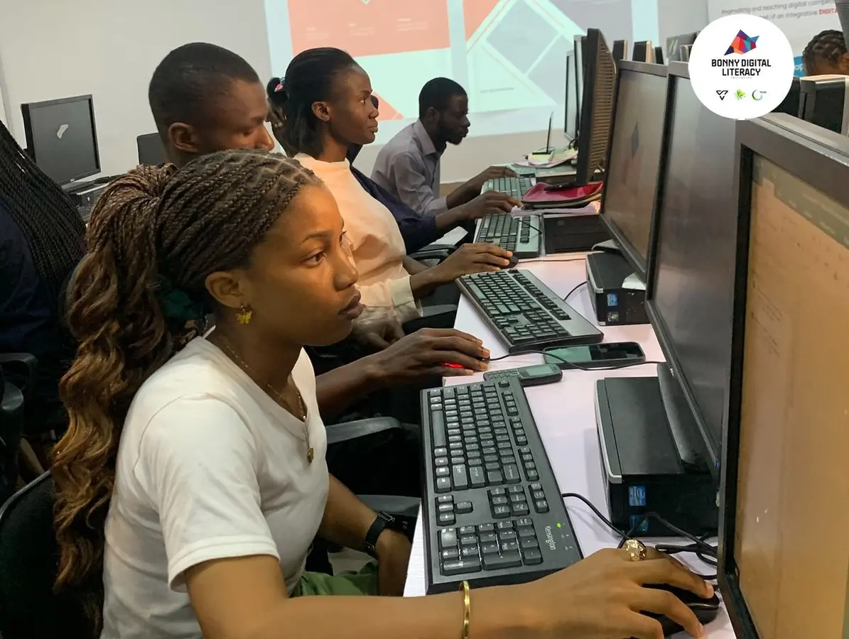 Learners working at computers during a NIIT collaborative technology workshop
